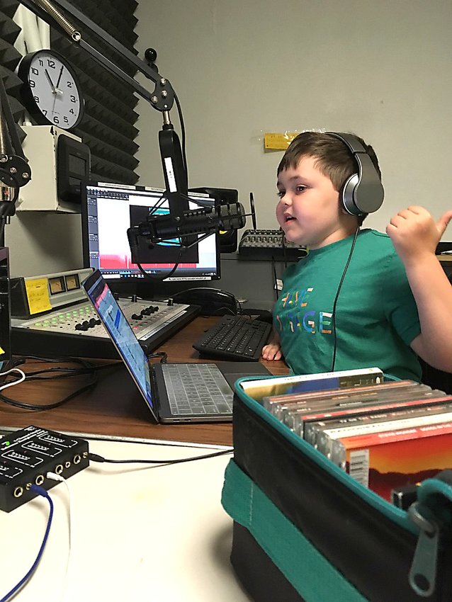 Murray Goff, who has cystic fibrosis, hosts a radio show with his sister, Olive, each Sunday morning on Frogtown WFNU 94.1. After interviewing real estate agent Kris Lindahl, they got a billboard to showcase their weekly episodes. (Photo submitted)
