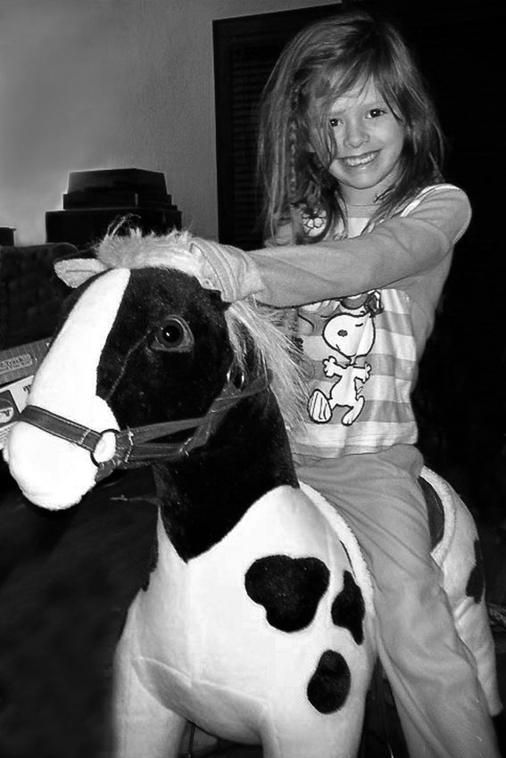 Erin Pavlica&rsquo;s daughter in 2013, riding the used upholstered horse that became the inspiration for the Midway-Frogtown Exchange. The group offers a place for Midway and Frogtown neighbors to buy, share and barter. (Photo submitted)