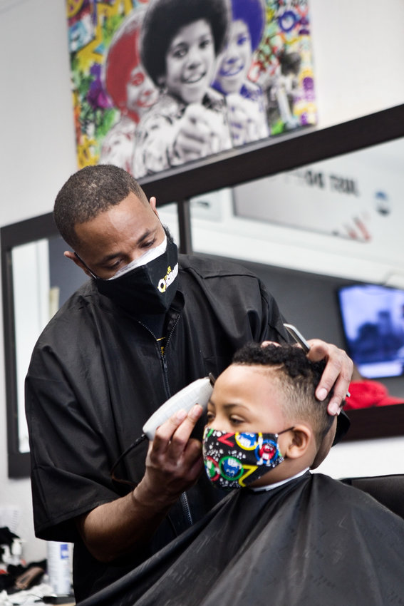 Milan Dennie, owner of King Milan&rsquo;s Barbershop said, &ldquo;We&rsquo;re a standout small business in the neighborhood because we stand for something positive.&rdquo; (Photo by Margie O&rsquo;Loughlin)