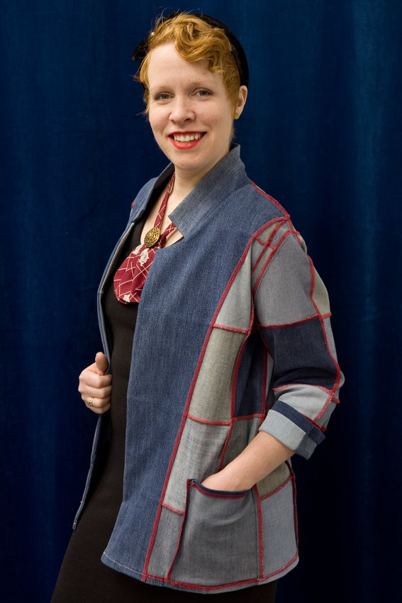 RETHINK owner Kristen McCoy in an upcycled denim blazer. She explained, &ldquo;To upcycle is to add value to something in the processing. We&rsquo;re able to take a worn garment and turn it into something new. We take jeans that are no longer wearable and cut them into denim squares. The result is a reversible blazer that still has a lot of wear. It&rsquo;s on sale at the shop, and is size fluid (small to large). (Photo by Margie O&rsquo;Loughlin)