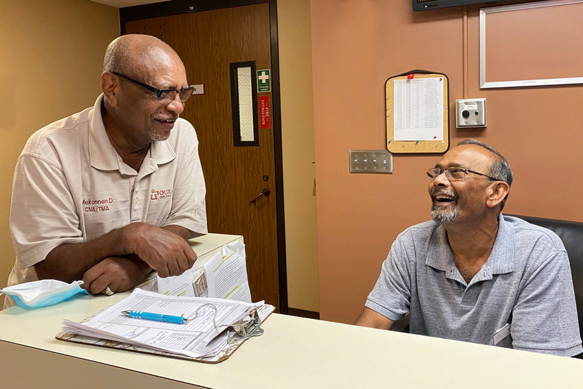 Mekonnen Dori (left) and Hari Pal (right) are longtime employees of Our Lady of Peace Hospice. Both have continued to work fulltime past the usual retirement age. Pondering his own eventual retirement, Mekonnen said, &ldquo;I don&rsquo;t know, maybe if Hari retires, then it will be time.&rdquo; (Photo by Margie O&rsquo;Loughlin)