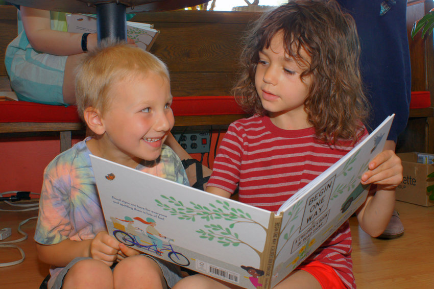 Neighbor Sylvie Wolfson is pictured reading with George.