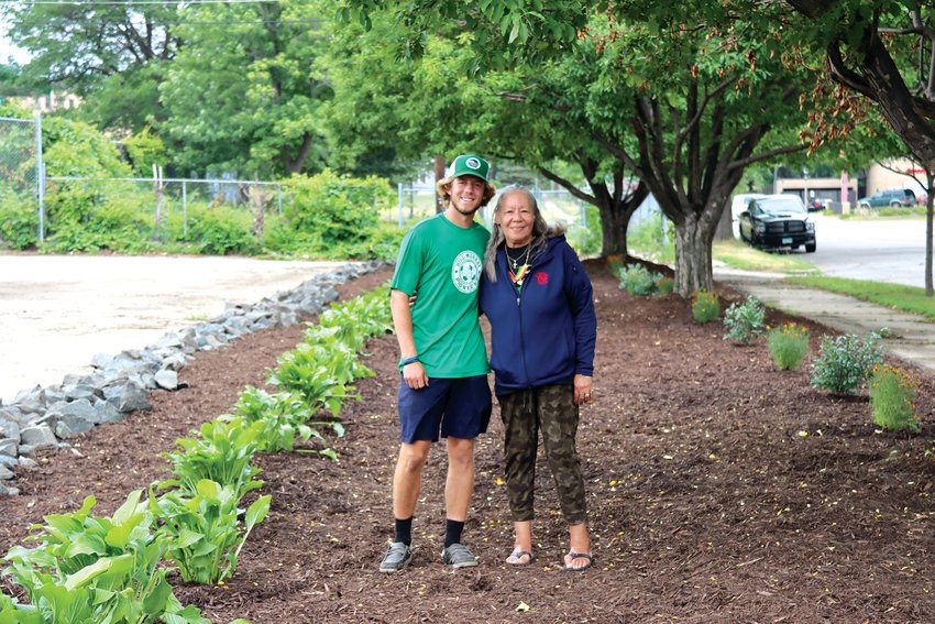 Joshua &lsquo;JP&rsquo; Yocum of Pioneer Landscaping and Lynn Wright appreciate how the new landscaping at St. Peter Claver Catholic School turned out. (Photo by Tesha M. Christensen)