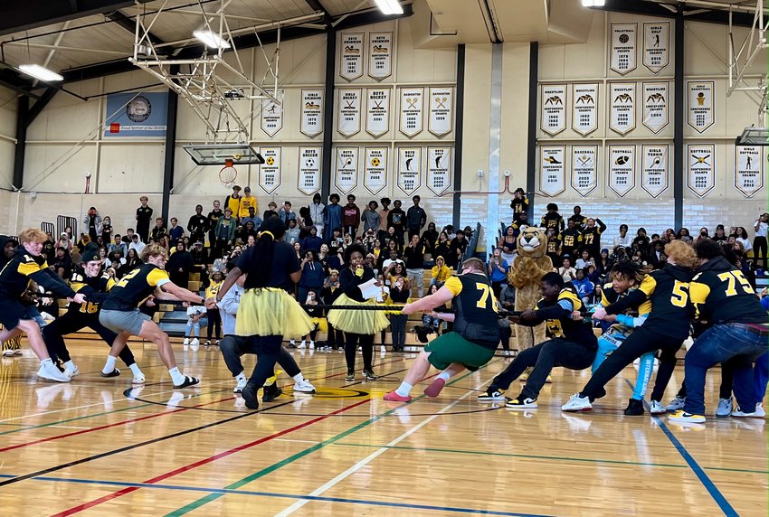 Seniors from the Class of 2023 (left) pull a team of juniors across the line in a tug-of-war contest at the Como Homecoming Pep Fest. (Photo by Eric Erickson)