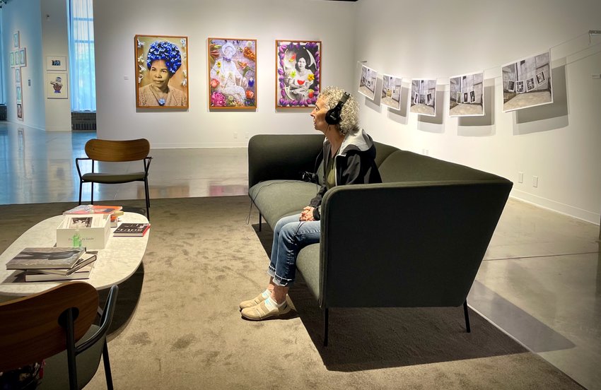 St. Paul resident, Robin Warshaw, enjoys the soundscape of &quot;A Picture Gallery of the Soul&quot; exhibit at the Katherine E. Nash Gallery on the University of Minnesota Campus West Bank. It runs through Dec. 10 and is free. (Photo by Susan Schaefer)