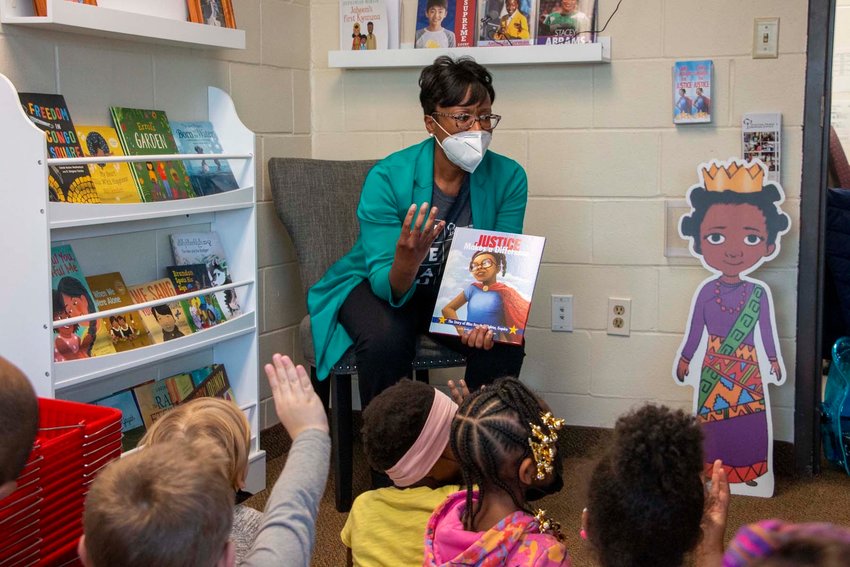 Artika Tyner reads &ldquo;Justice Makes a Difference&rdquo; to preschoolers at the Wilder Child Development Center, which is the home of the new R.A.W. library. (Photo submitted)