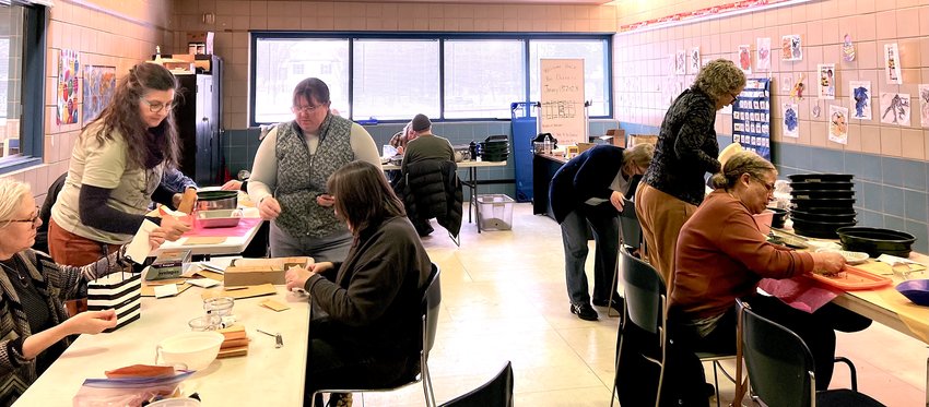 Volunteers clean and package native seeds for distribution at a MN SEED workshop in January. Cleaning and packaging the seeds is just one step in the process. (Photo submitted)