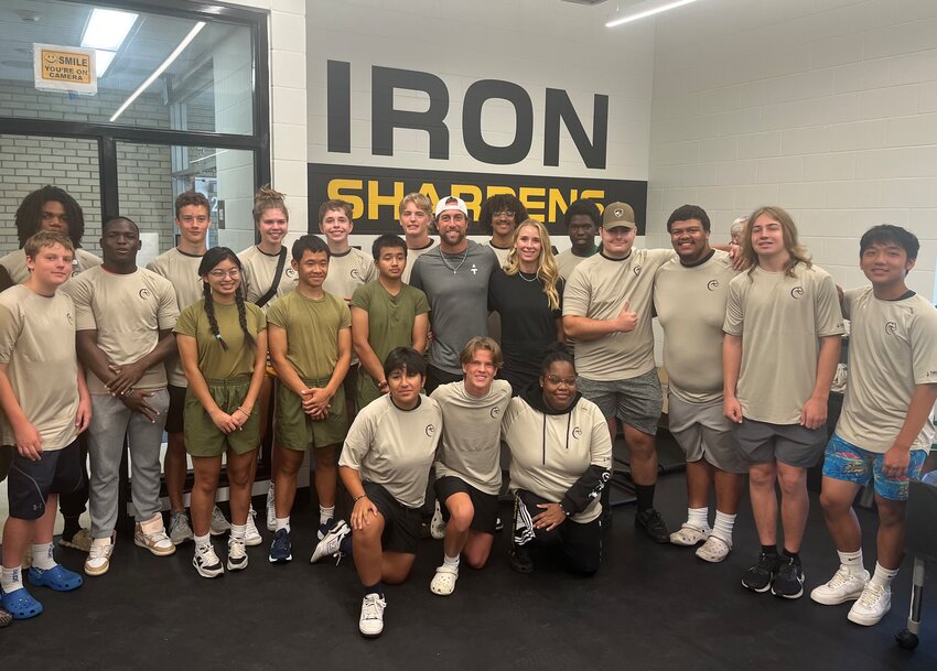 Adam and Caitlin Thielen joined Como students for the dedication of the school&rsquo;s new weight room.