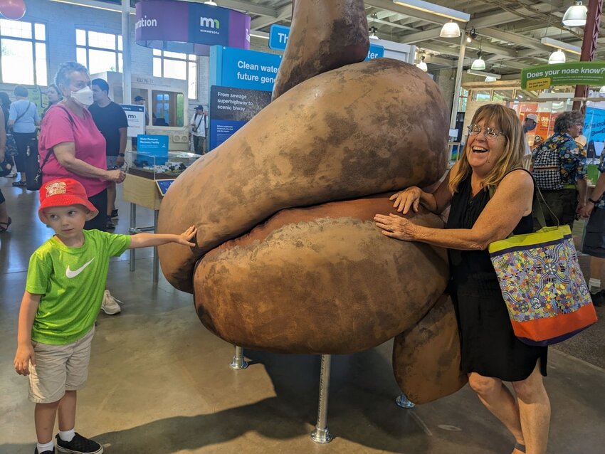 Patricia Ohmans (right) of Frogtown Green checks out the &ldquo;Water Resource Recovery: Removing Poo for (Nearly) Pure Water&rdquo; exhibit. (Photo by Frogtown Green)