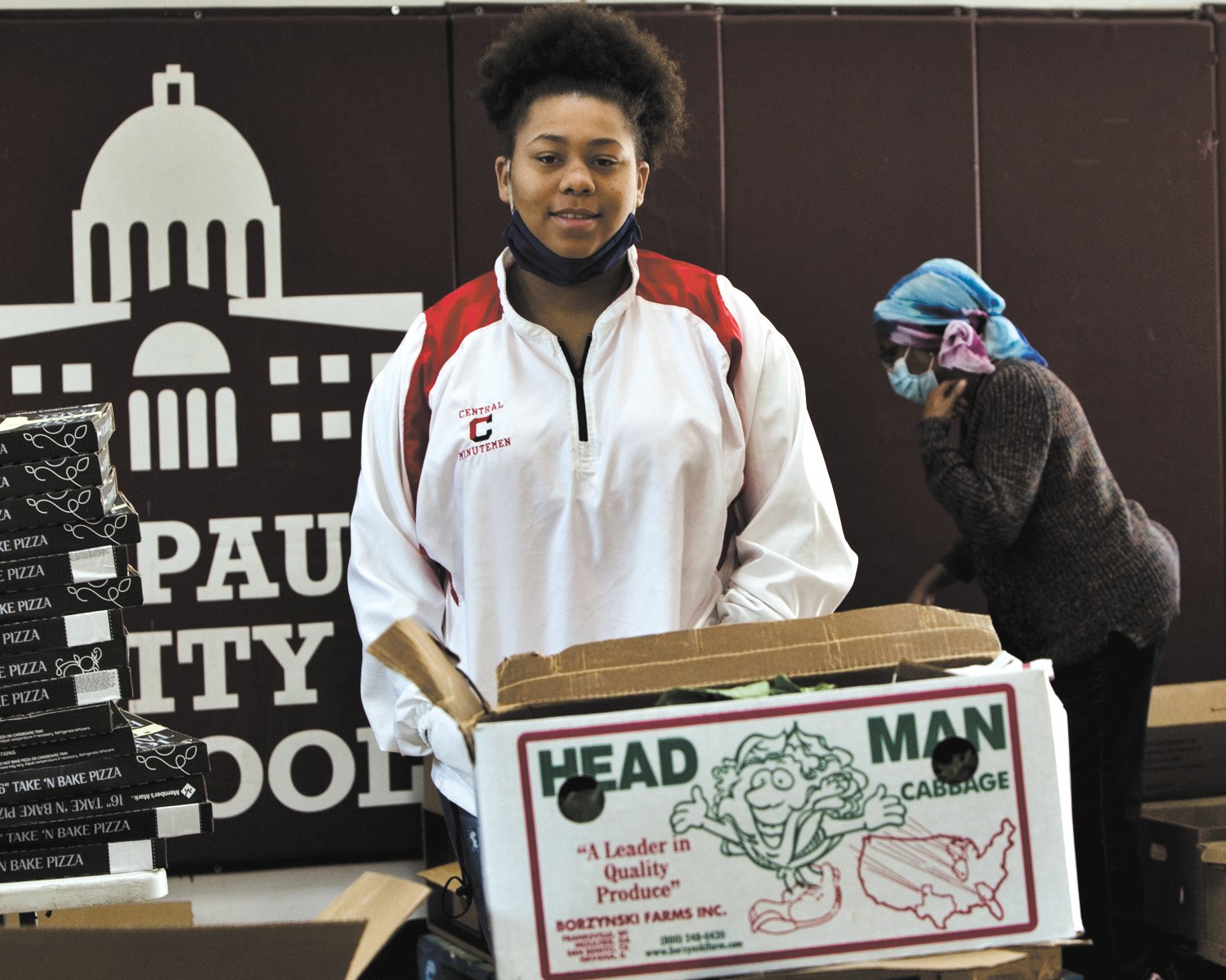 Jareen Eason-Fearson is one of many Frogtown residents who helps sort and pack food items for distribution on Friday afternoons at St. Paul City School. (Photo by Margie O’Loughlin)
