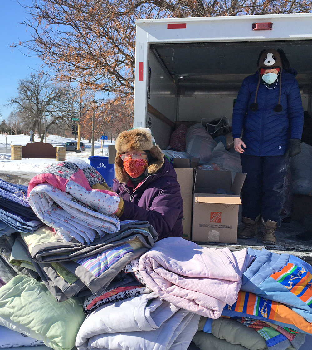 Volunteers Joanne Swanson and Annie Huidekoper wrangle with some of the donations from Como residents.
