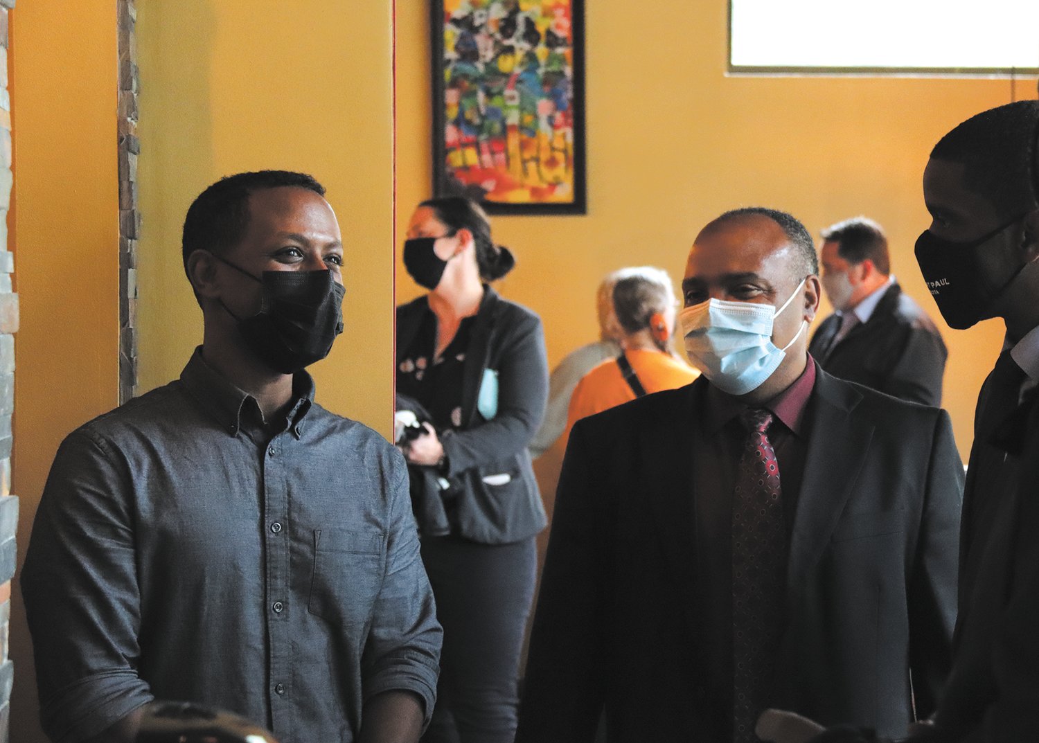 olomon Hailie (left), who owns Bole Ethiopian with his wife, Rekik Abaineh, chats with African Economic Development Solutions Executive Director Gene Gelgule (center) and St. Paul Mayor Melvin Carter during the ribbon cutting event on May 27, 2021, one year after the restaurant burned to the ground in the civil unrest along University Ave. after George Floyd’s murder.

“When we needed something, we knew who to call,” stated Hailie. “We appreciate your support and love.” They received a $50,000 grant through the We Love St. Paul/We Love Midway fund to help with the new space in the former Fox Trot Burger (1341 Pascal Street). “Thank you for leading the way,” said Midway Area Chamber of Commerce Executive Director Chad Kulas. (Photos by Tesha M. Christensen)
