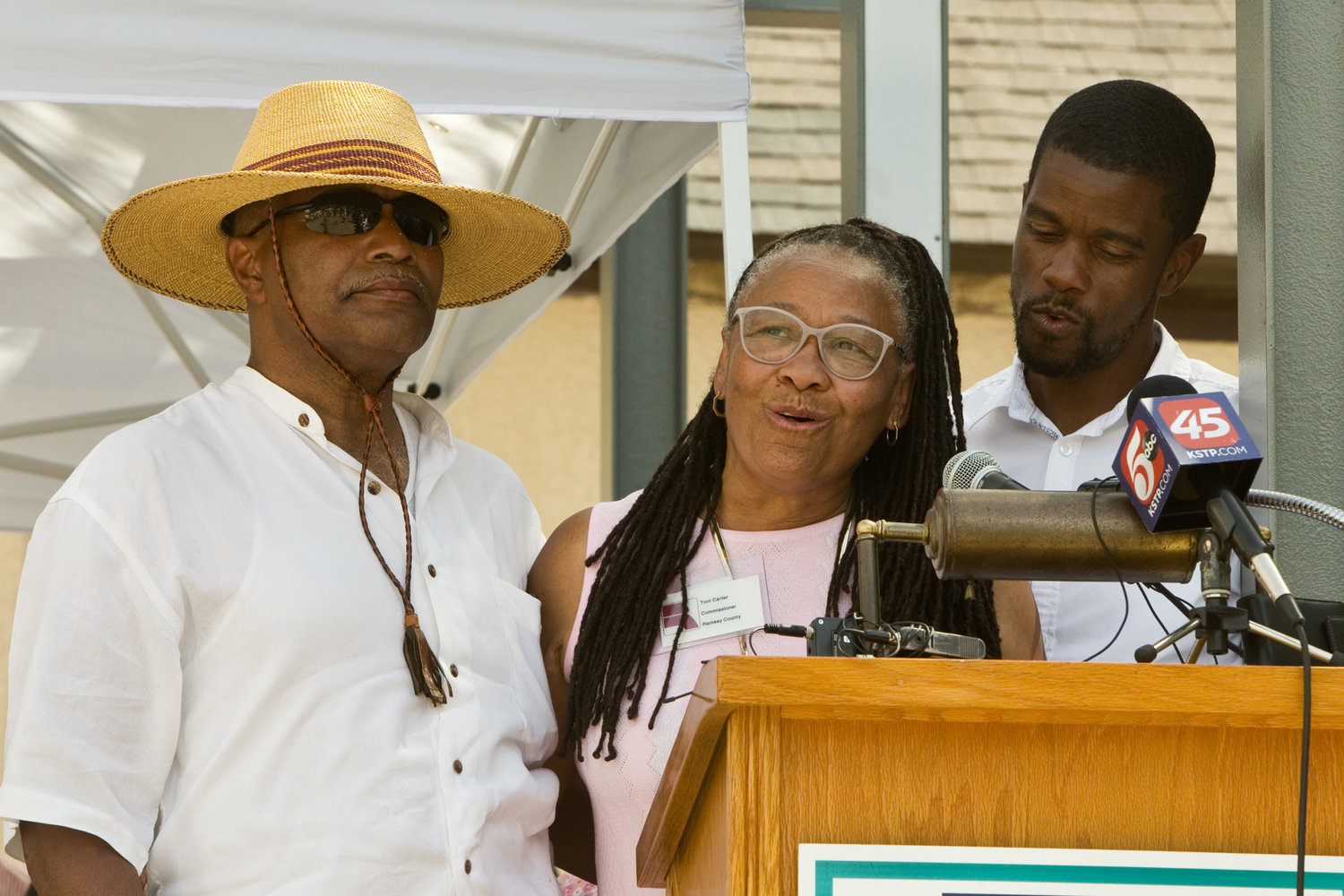 Ramsey County Commissioner Toni Carter (center), husband Melvin Carter Junior (left) and son St. Paul mayor Melvin Carter III (right) commemorated their family’s original Rondo home that was uprooted during the construction of I-94 by planting a tree during the Juneteenth Celebration at the Rondo Center of Diverse Expression at 315 Fisk St. (Photo by Margie O’Loughlin)