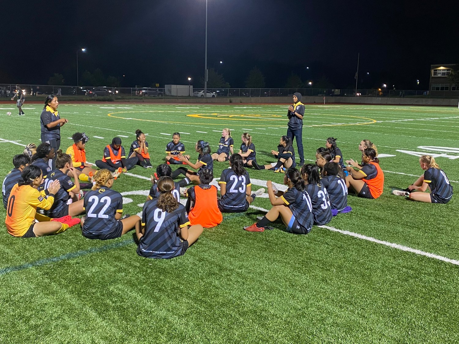 The Cougar girls soccer team gathered on the Como turf after their opening match of the season (Photo by Eric Erickson)