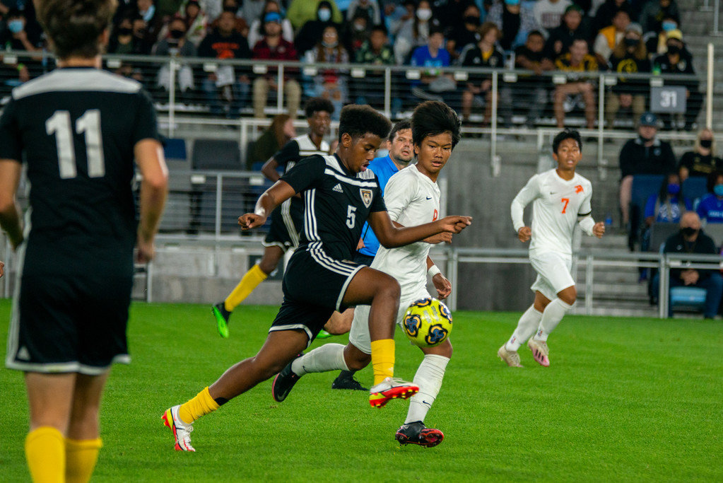 Como Park High School player Khadar Aden works to advance past a Humboldt defender during the Mayor’s Cup on Friday, Oct. 8, 2021. About 2,000 local families filled Allianz Field for the event. For most, it was their first time inside a professional stadium. The Mayor’s Cup has been held annually since 2016. The Como boys team lost in a 4-3 match, and the girls won 1-0. (Photo by Rob Spence)
