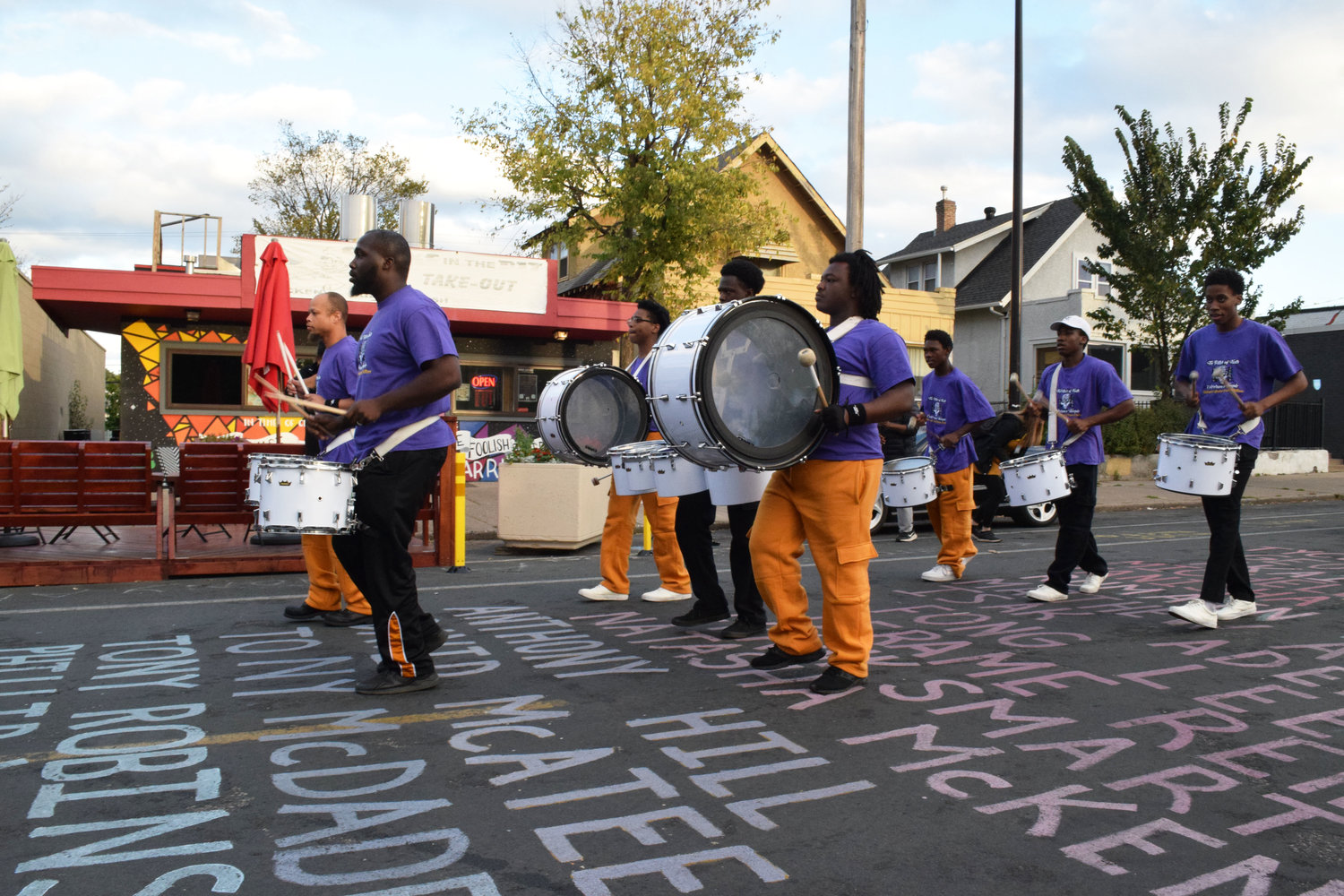 The Lions of Judah Drum Drill Team march their rhythms up Chicago Ave. (Photo by Jill Boogren)