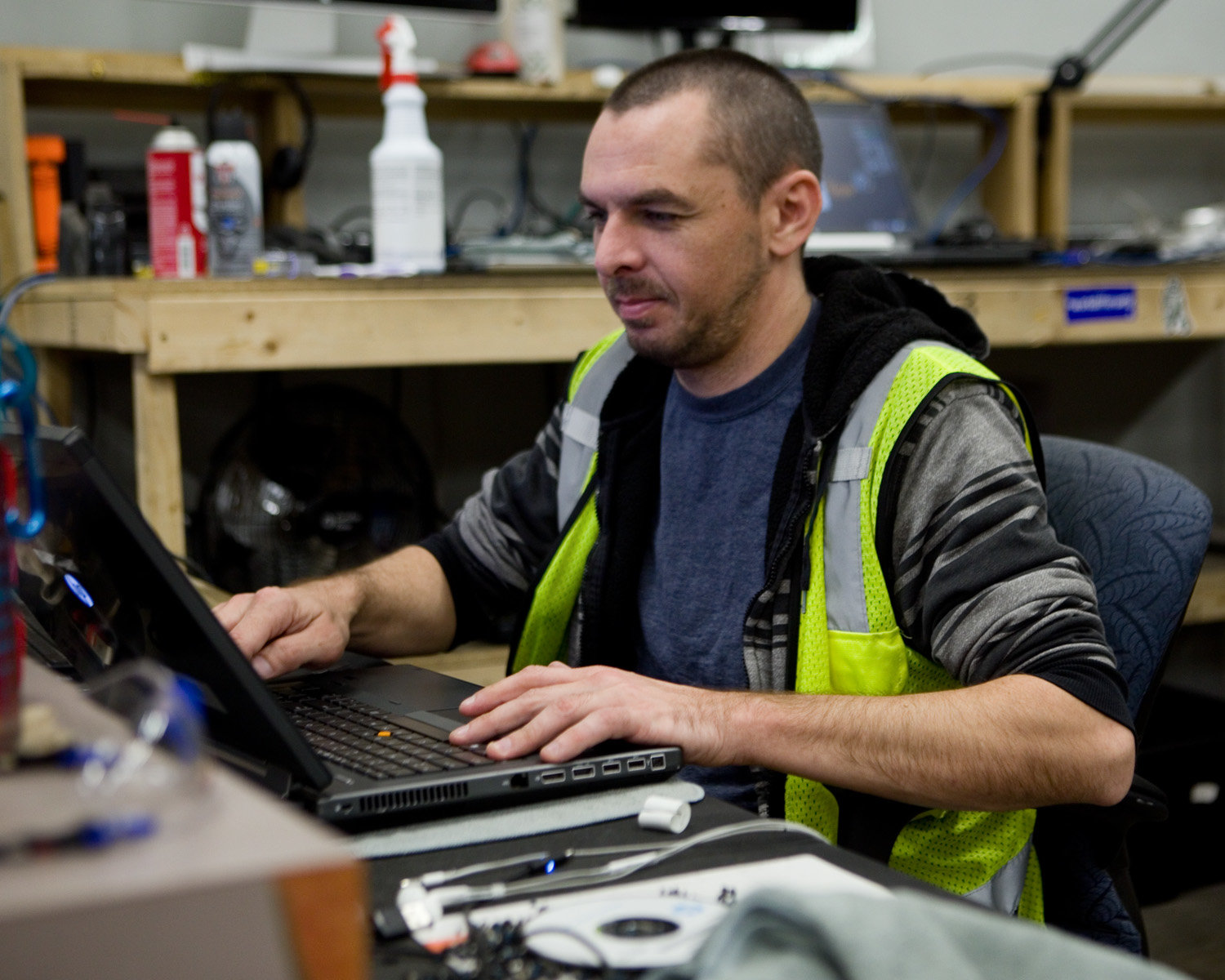 Laptop Technician Scott Holmstrom tests a laptop to determine what repairs are needed before it can be ready for sale.