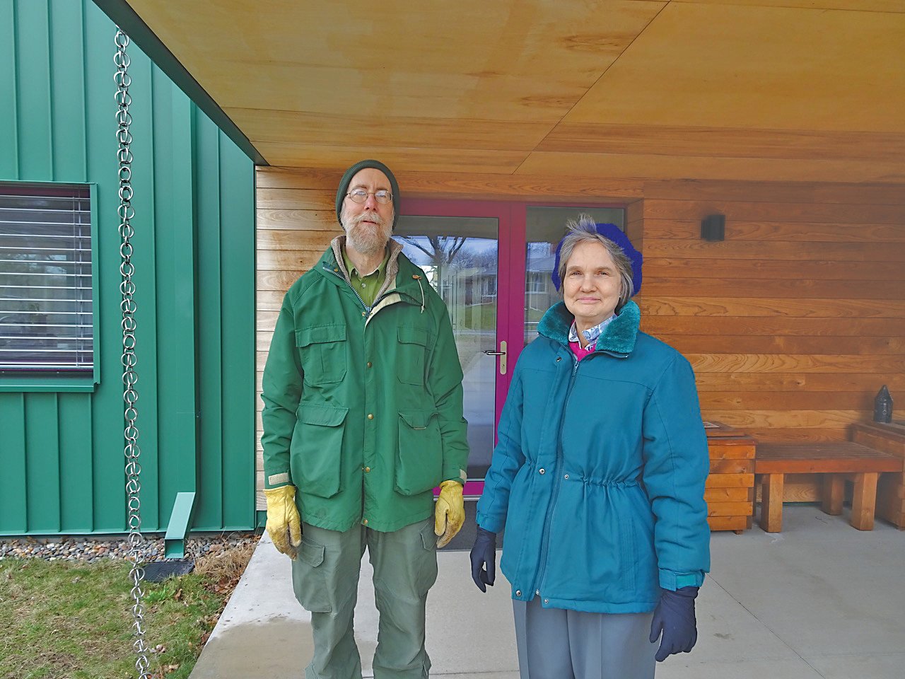Dave Crawford and Diane Peterson stand in front of their entryway.