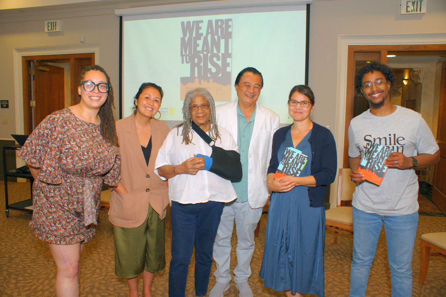 Writers and editors celebrate the launch of “We Are Meant To Rise: Voices of Justice from Minneapolis to the World.” Left to right: Tess Montgomery, Samantha Sencer-Mura, Carolyn Holbrook, David Mura, Anika Fajardo, and Suleiman Adan. (Photo by Terry Faust)