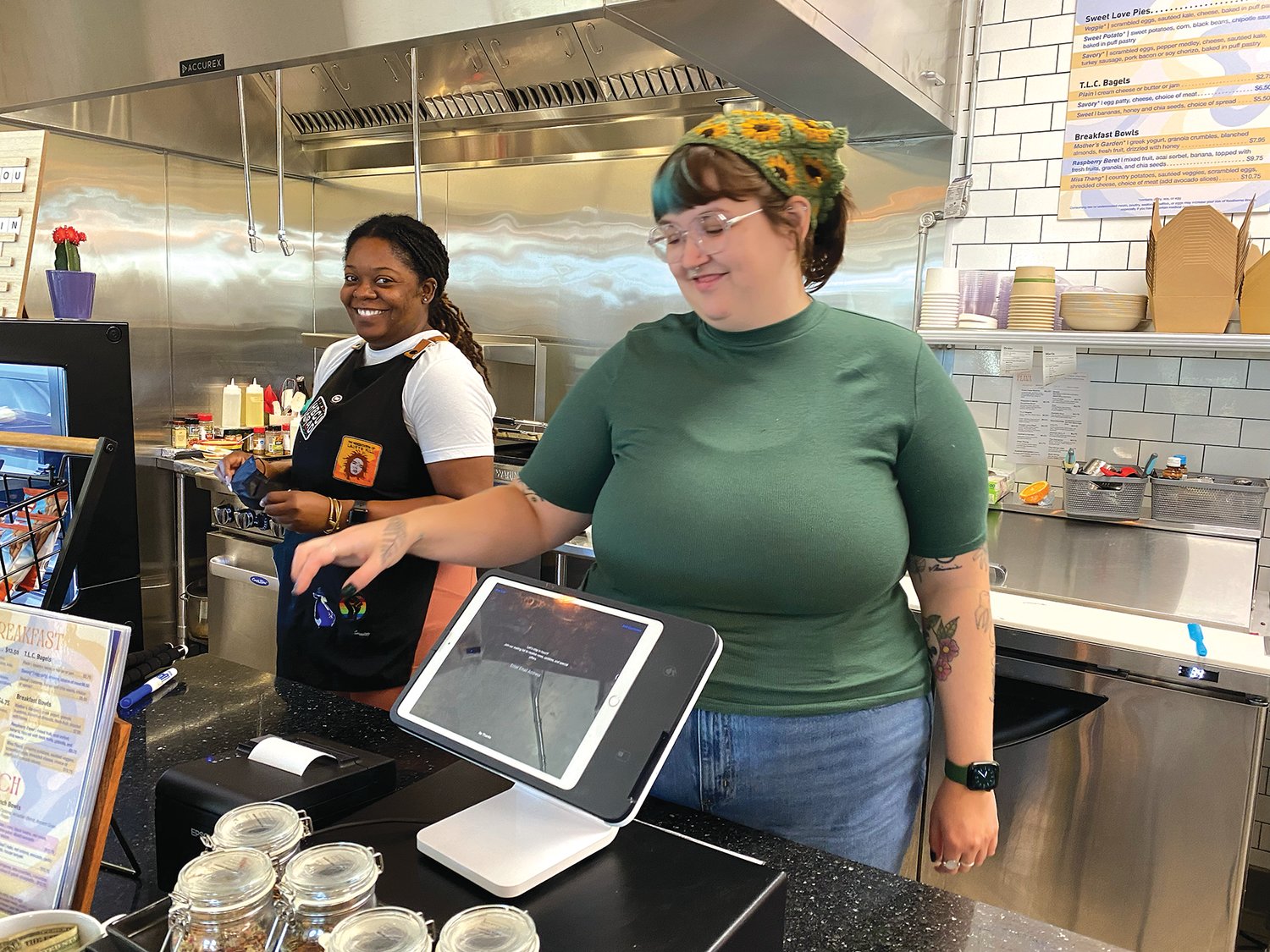 Owner Shaunie Grisby (left) and Alexa Clausen serve customers at Flava (623 University Ave. W.), the neighborhood’s newest coffee shop. (Photo by Tesha M. Christensen)