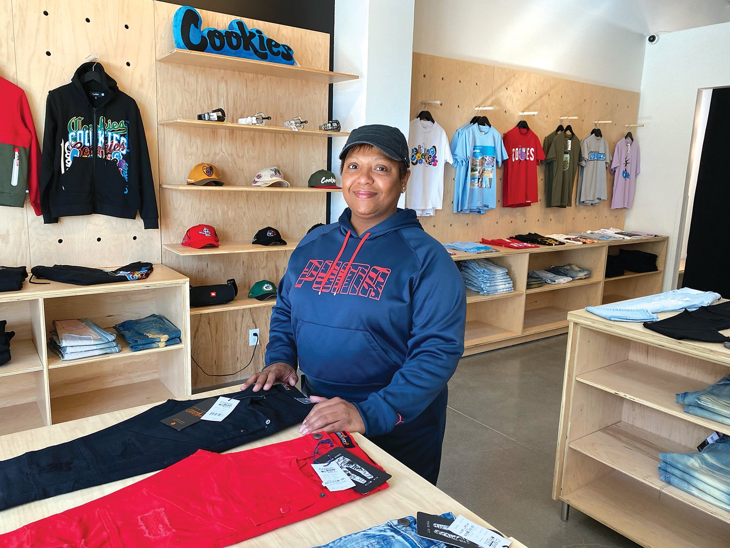 Urban29 owner Joyce Sanders stands in her new store at 633 University Ave. W., in the new Frogtown Crossing building. (Photo by Tesha M. Christensen)