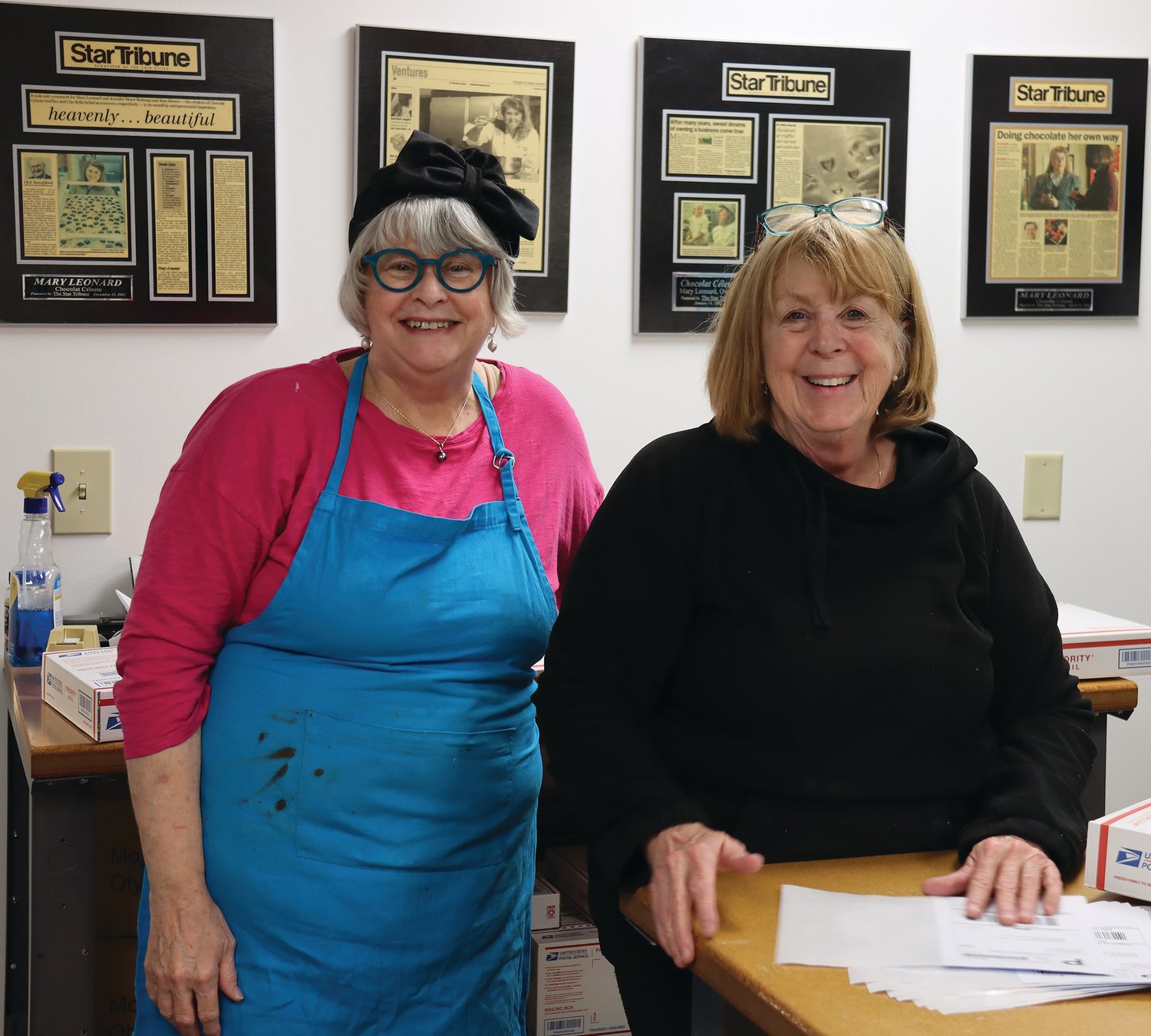 Chocolat Céleste owner Mary Leonard (left)  and worker Stephanie Drake met in chemistry class at Highland Park High School. Today, they work together making and shipping chocolates. (Photo by Tesha M. Christensen)