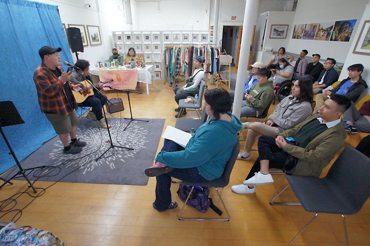 Yeej (left) and Randy Xiong perform during a recent open-mic night at In Progress (shown above and below). In Progress has about 30 part-tome staff, including interns, at its two locations. The organization started off in Lower Town but outgrew that space and moved to the Front Ave. building in 2011. The building is open for use from 7 a.m. until midnight.