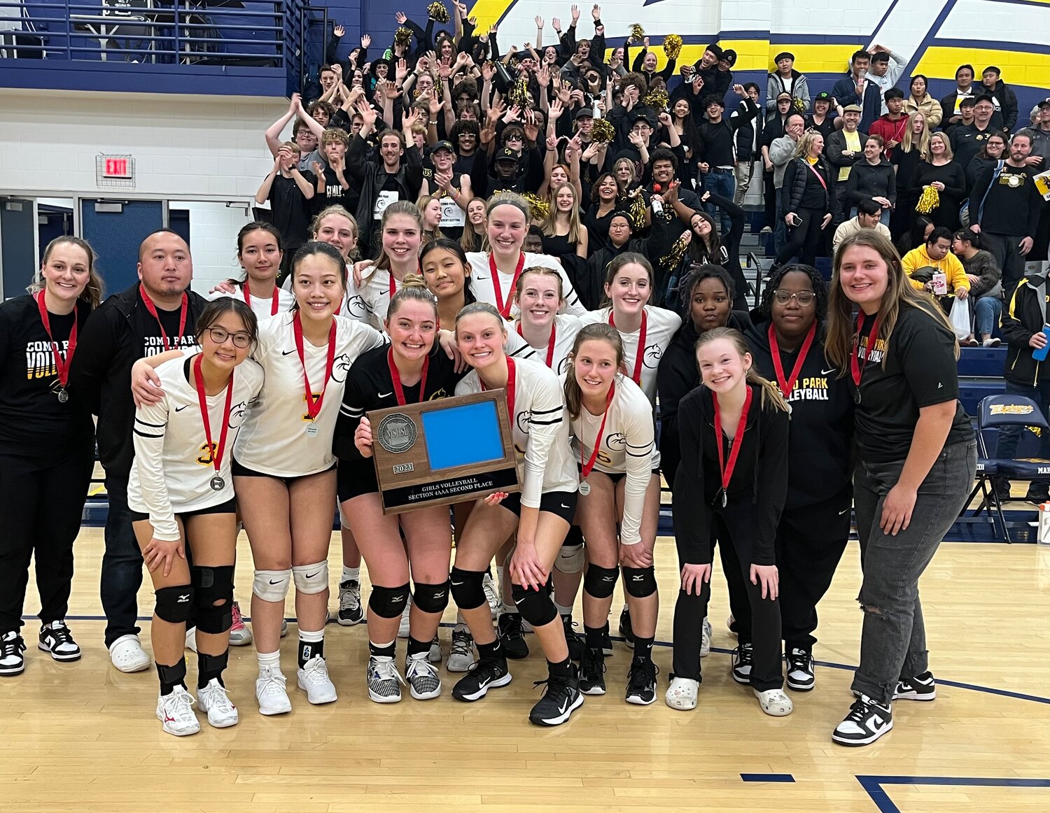 The Como volleyball reached the Section 4AAA Championship. The team is pictured with their second place trophy in front of their loyal supporters.