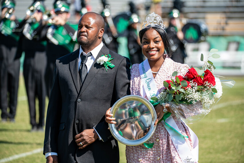 PRECIOUS R THOMAS is escorted by her father Damian Thomas at UAM’s 100th Homecoming Celebration where Thomas was crowned as Homecoming Queen before the Weevils took the field to face Southeastern Oklahoma State University on Saturday.