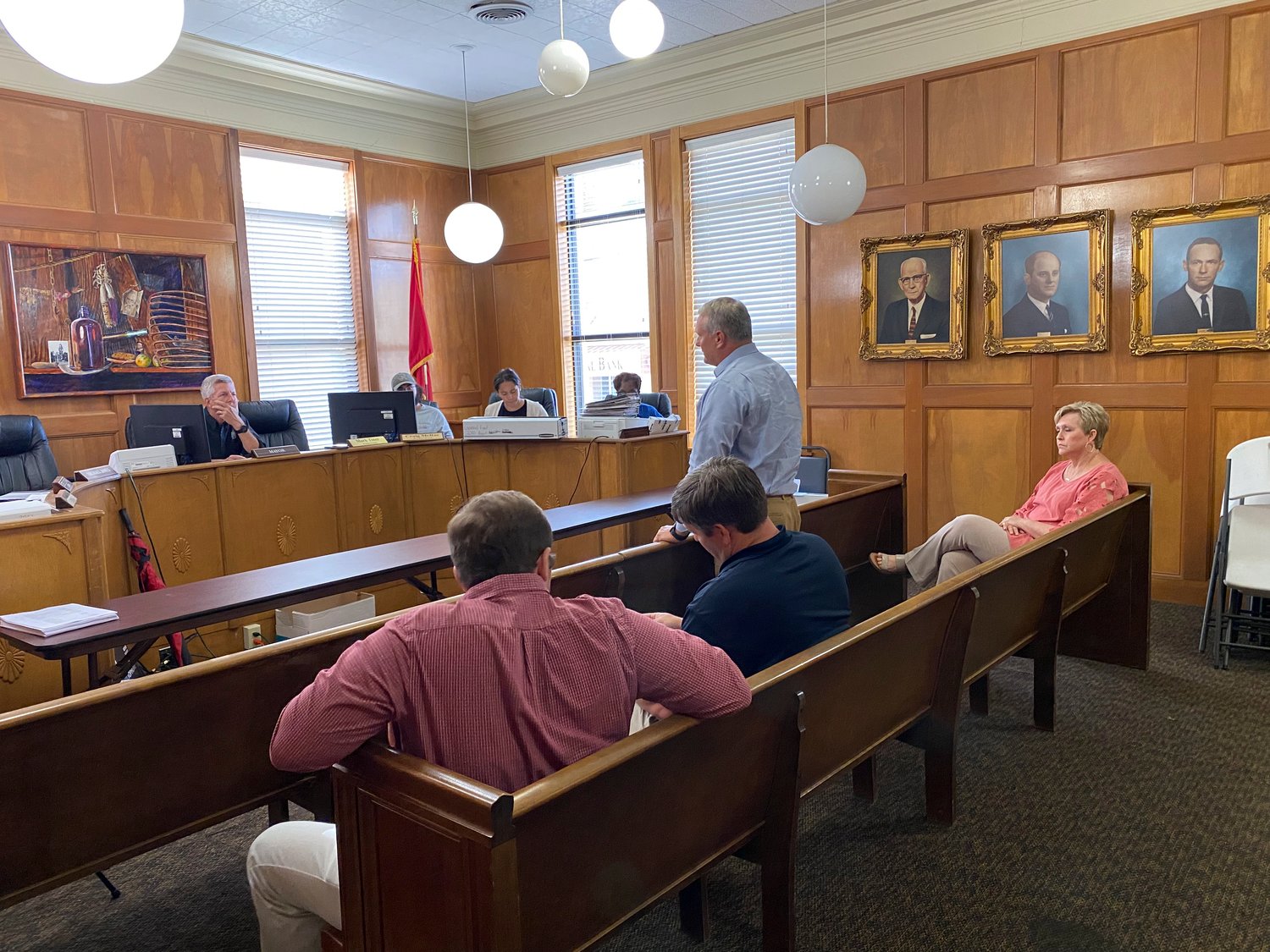 Planning Commission Chairman Dan Boice. (Left, seated) listened intently along with other members of the Commission as Byron Hicks (Center, standing) explained the 15 year plan for the City of Monticello.