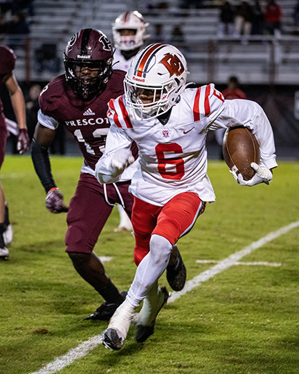 JA’CORRIAN LOVE attempts to get to the outside on one of his runs on Friday night
