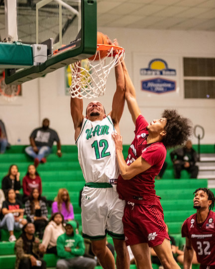 ISSAC JACKSON slams one home over a Henderson State defender. Jackson has led the Weevils in scoring in their first two GAC contests scoring 21 at Arkansas Tech and 23 against Henderson.