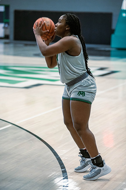 AZARIA HULBERT shoots a three-pointer against Arkansas Tech. Hulbert has scored a total of 15 points in the Blossoms last three contests. Hulbert scored five against Tech, two at Henderson, and eight against SAU.