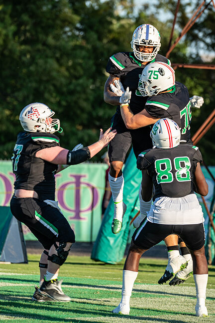 JAVONNIE GIBSON celebrates with his teammates after scoring the third Weevil touchdown of the game, a 50-yard pass reception from Demilon Brown.
