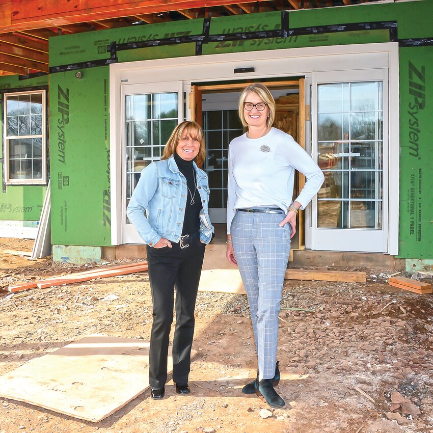 Executive Director Kim Cahill Yannuzzi and Sales and Marketing Director Kathryn Koenig stand at the front entrance of The Birches at New Hope. Construction is anticipated to be complete by fall 2025.