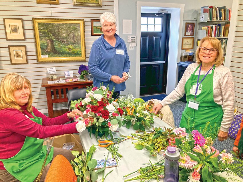 Countryside Gardeners’ members (from left) Linda Rubini, Kathy Lundy, and Monica Konig participate in the garden club’s floral design workshop.