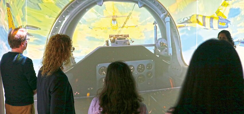 Participants enjoyed the experience of being a jet fighter pilot in the new Immersive Reality (IR) room at the Fab Lab Center."