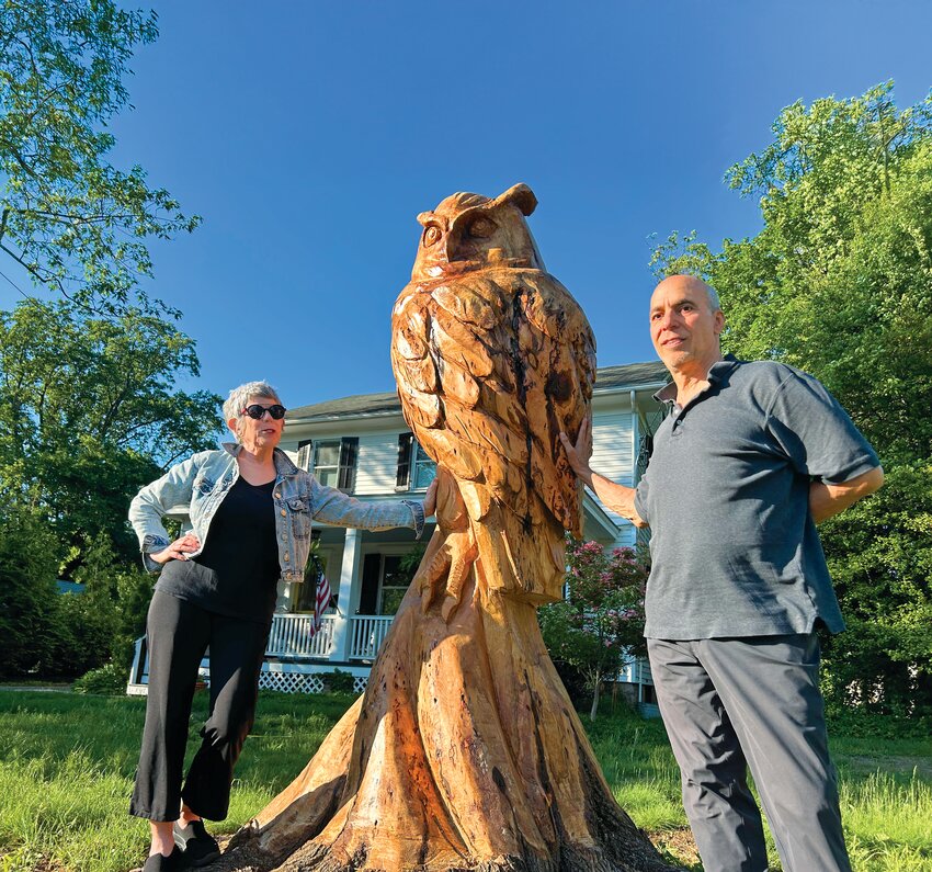 Cindy and Lampros Fatsis and their newly carved wooden owl sculpture.