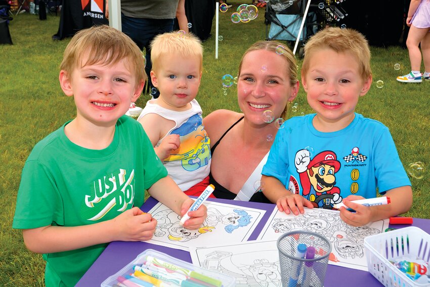 From left: Clark, Rhys, Ashlee, and Fynn Gower, all from Holland, have fun coloring and making bubbles.