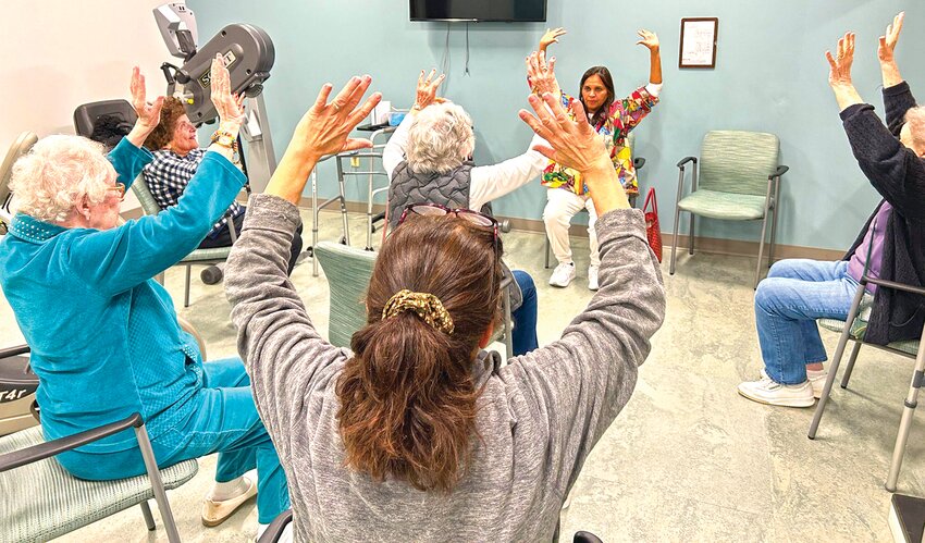 Mind and body in motion! Residents at Pickering Manor enjoy chair yoga—an activity proven to support brain  health by improving circulation, focus, and mood.