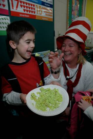Kindergarten teacher Erika Augustyn tries to feed her student Jonah Hebda some green eggs and ham.