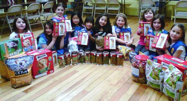 Troop 290 collect 100 pound of dog food in honor of the 100 years of Girl Scouts!