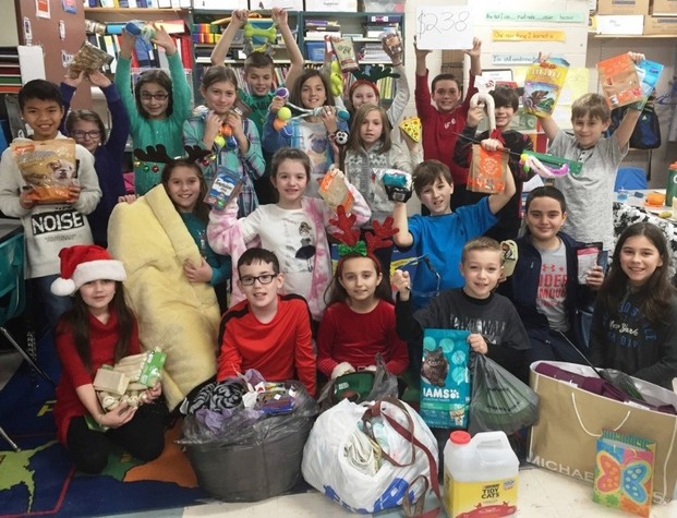 Fourth graders at Palmer River in Grade 4 with their donations.
