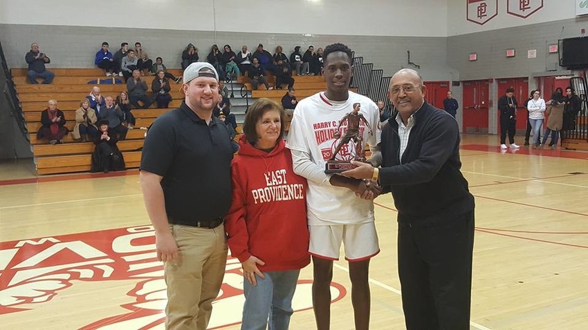 Mutter tourney MVP being presented to Deyshawn Tengbeh by Nick Mutter, Pat Cabral McKinnon and Junior Butler.