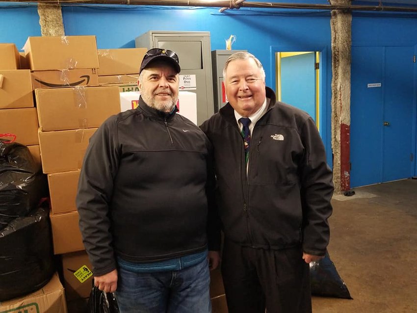ROVAC co-ordinator Steven Perry, L and Tony DeJesus of Big Blue Bug Solutions during the collection of Christmas gifts for RI veterans.