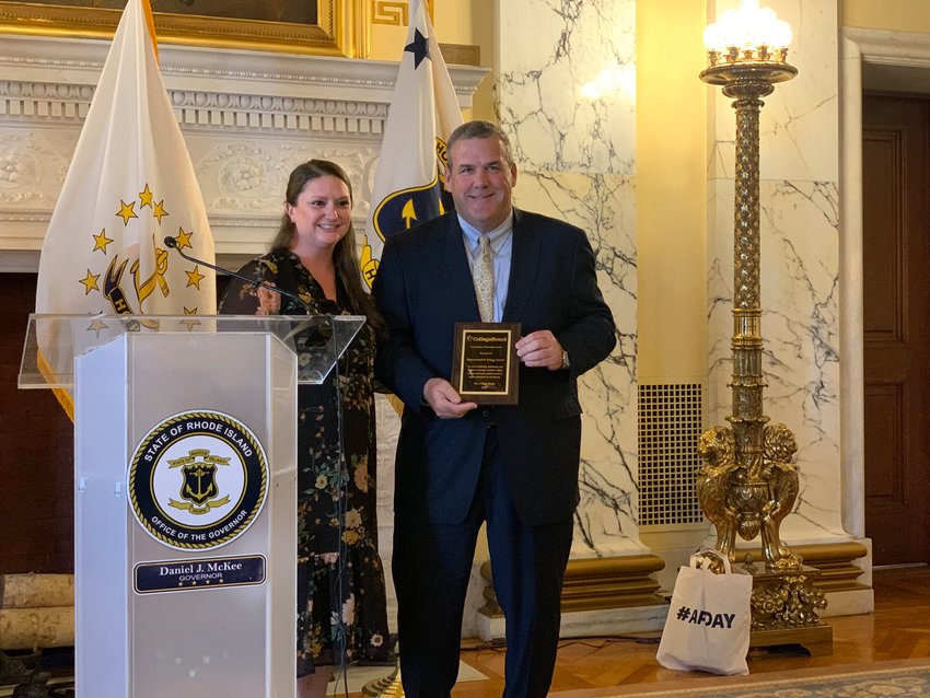 Rep. Gregg Amore, right, accepting the 2022 Policymaker Award from Julie Harris-Lawrence, Sr. Director of Teacher Outreach Government Relations at College Board.