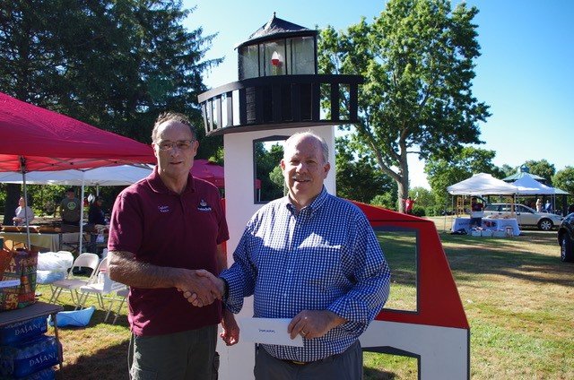 Dennis Tardiff of Friends of Pomham Rocks Lighthouse, left, accepts grant check from Paul Williams, board member of Squantum Association.