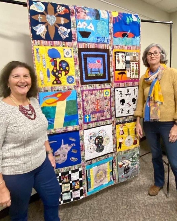 Cila daSilva and Leslie Guglielmo with the finished quilt.