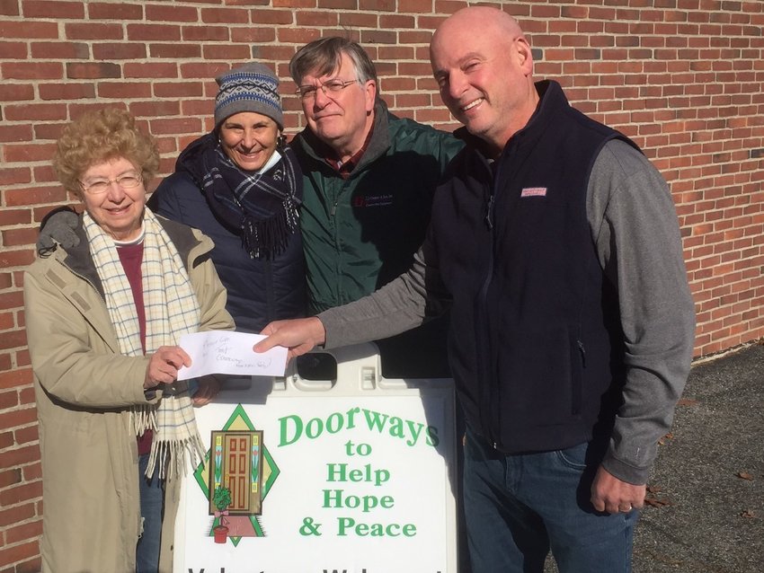Lucky&rsquo;s Pub raised $4,000 to combat hunger, with the funds being split between food pantries in East Providence and Seekonk. (Above) Mike Tortolani, representing Lucky&rsquo;s Pub, presents a check for to Diane Fox, Suzie Miller, and Gerry McCabe of Doorways.