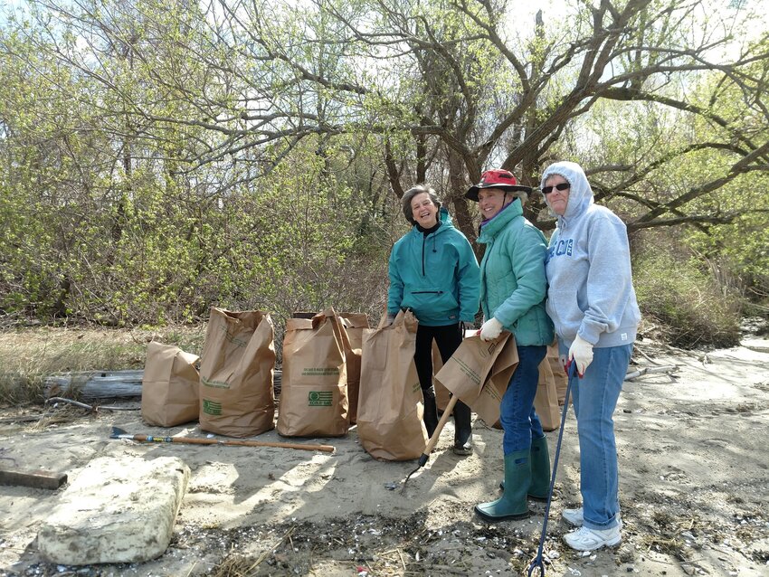 Pam, Mary, Ellen with bags for spring cleanup.